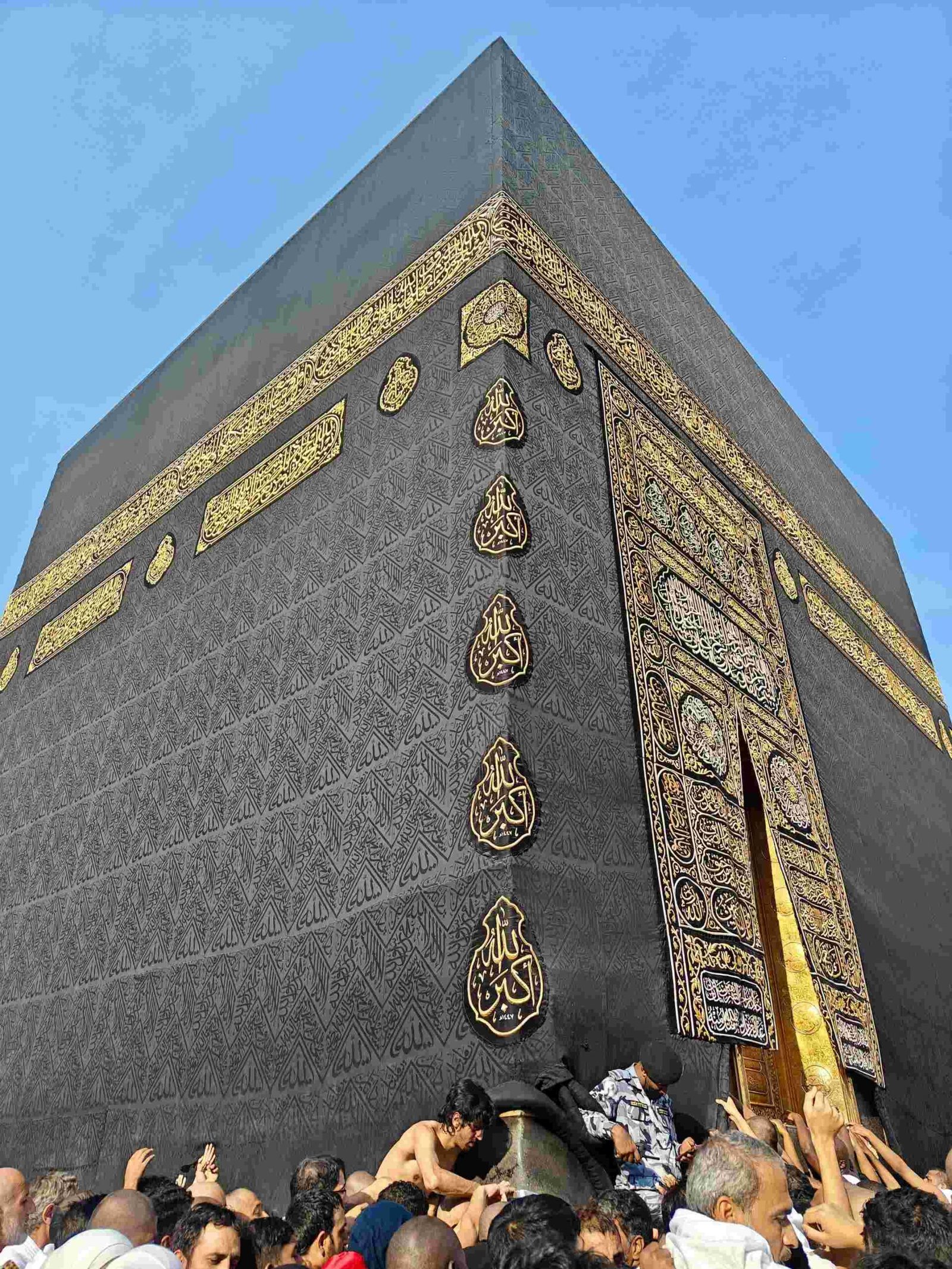 Close-up view of the Kaaba showing the black Kiswah cloth with golden Quranic embroidery
