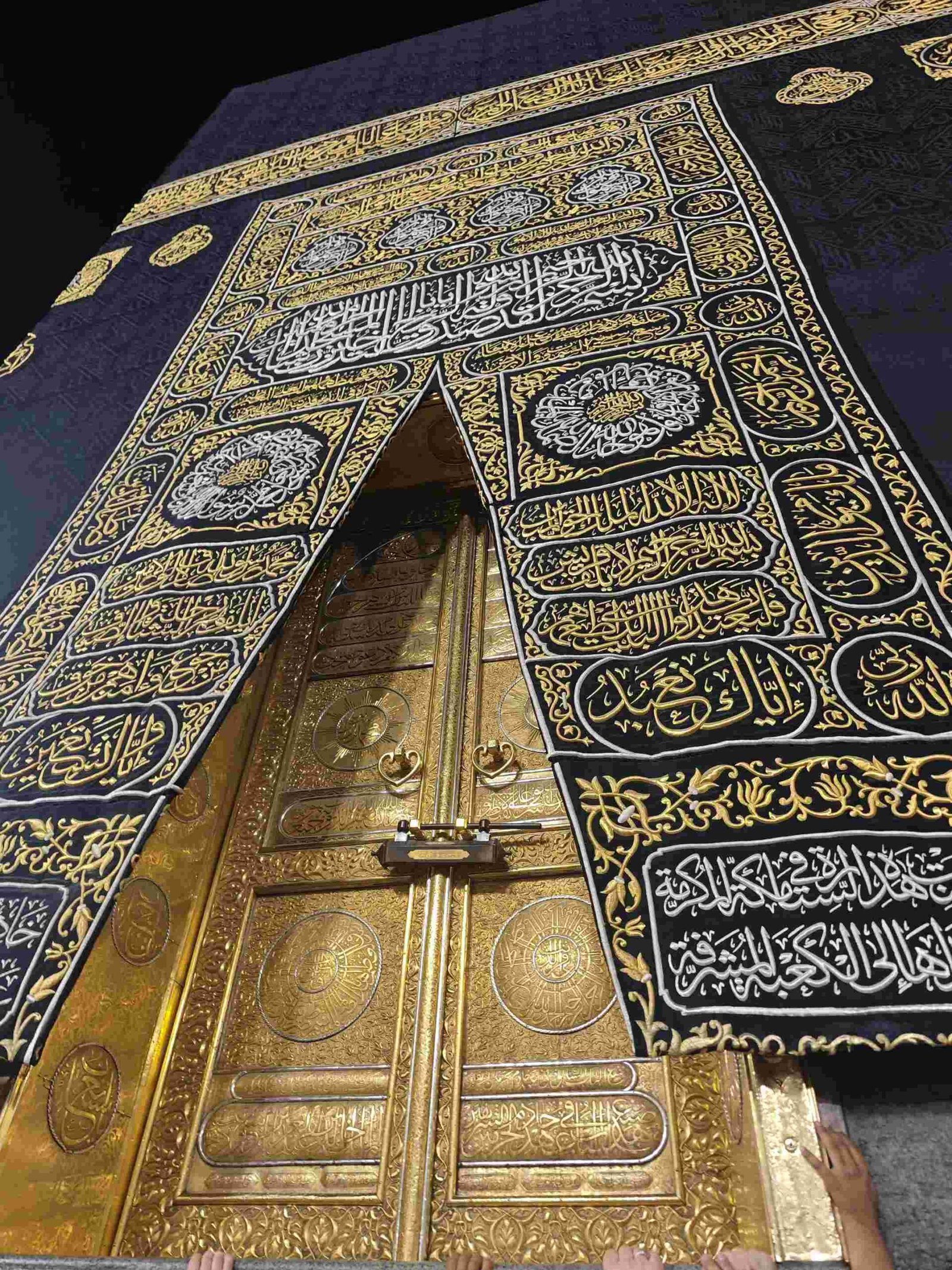 The Kaaba seen from the courtyard of Masjid Al-Haram, surrounded by pilgrims in white